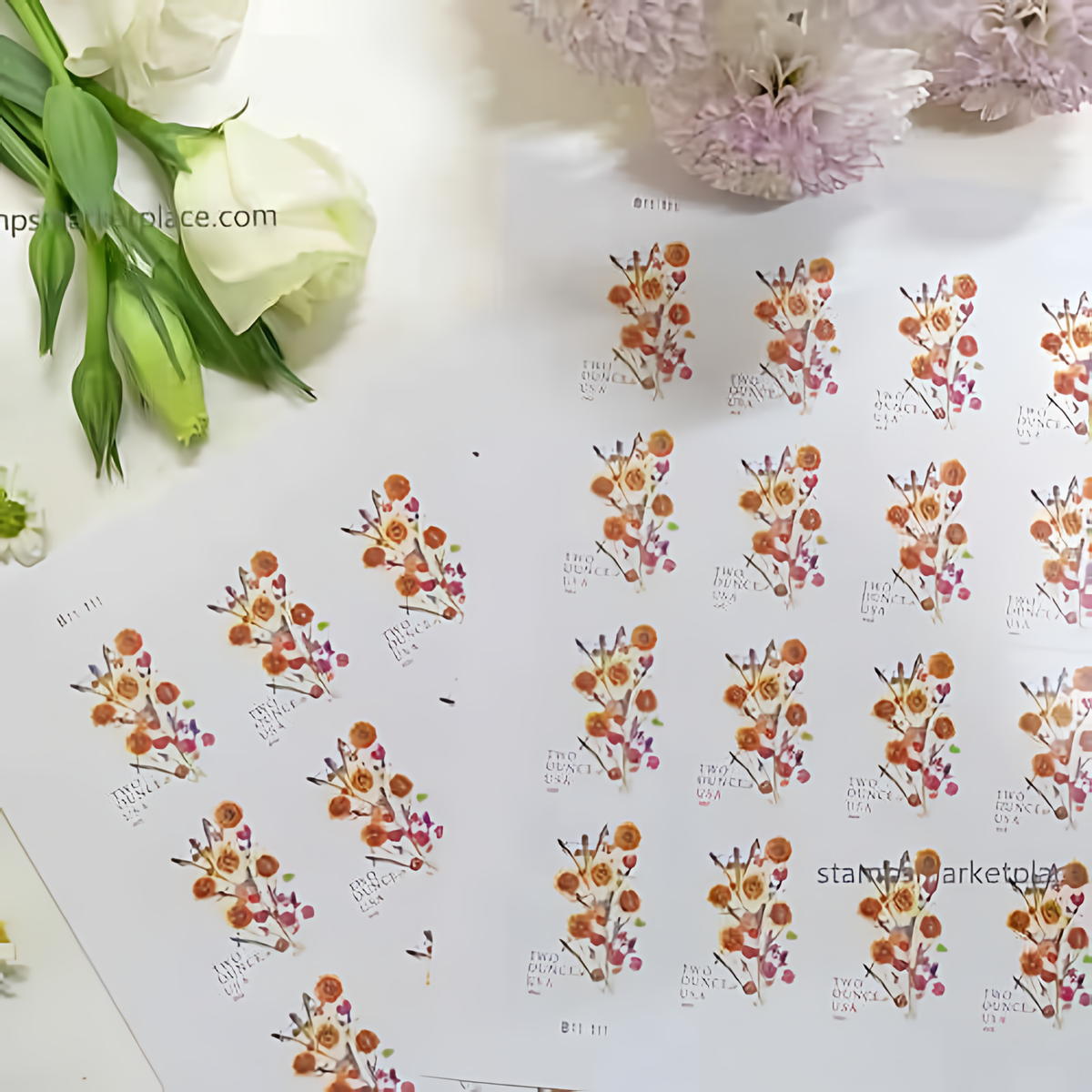 2022 Sunflower Bouquet stamp sheets beside white flowers