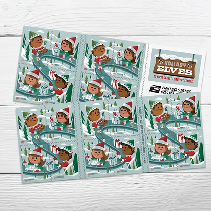 Holiday Elves stamp booklet pane on a white wood surface