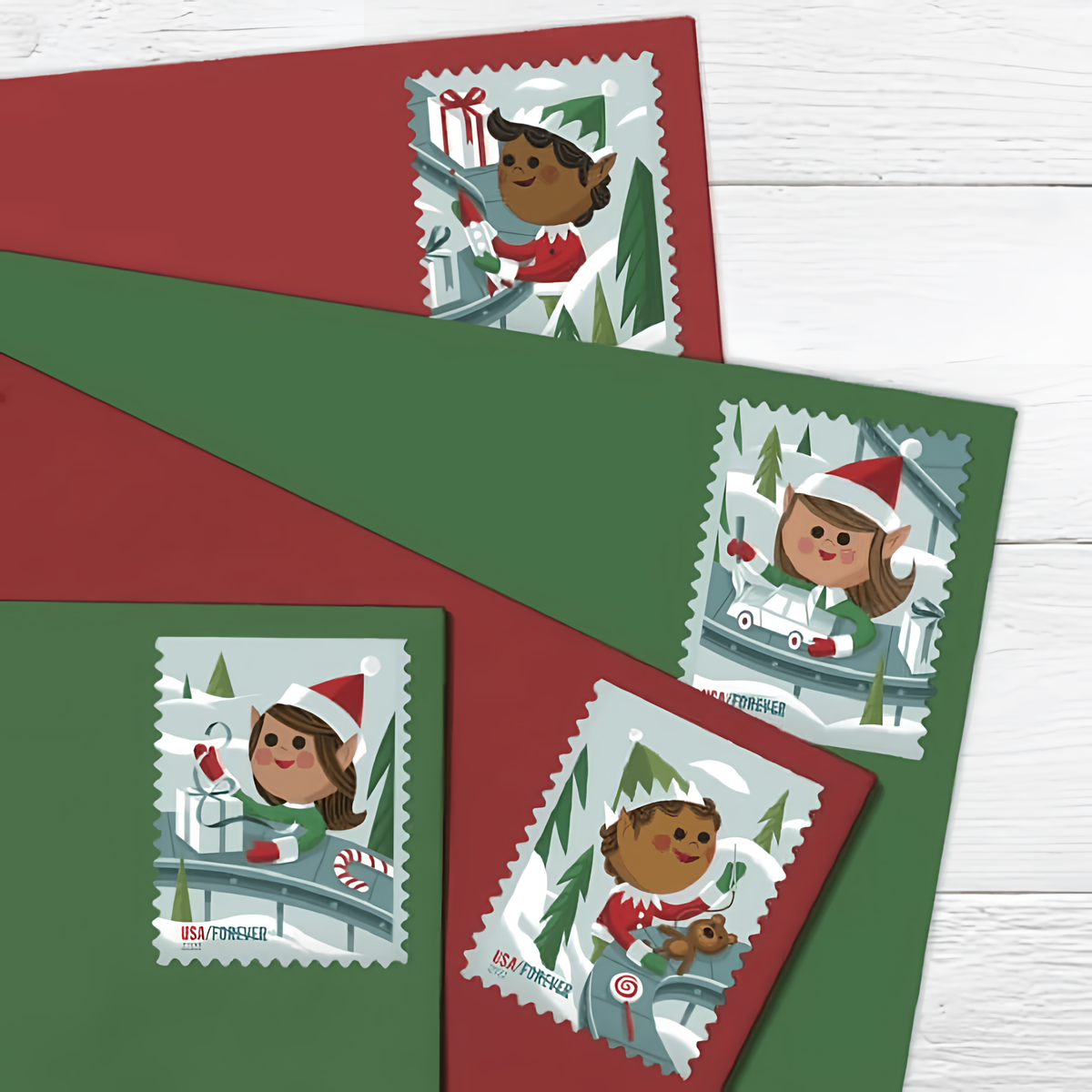 Holiday Elves stamps on red and green envelopes